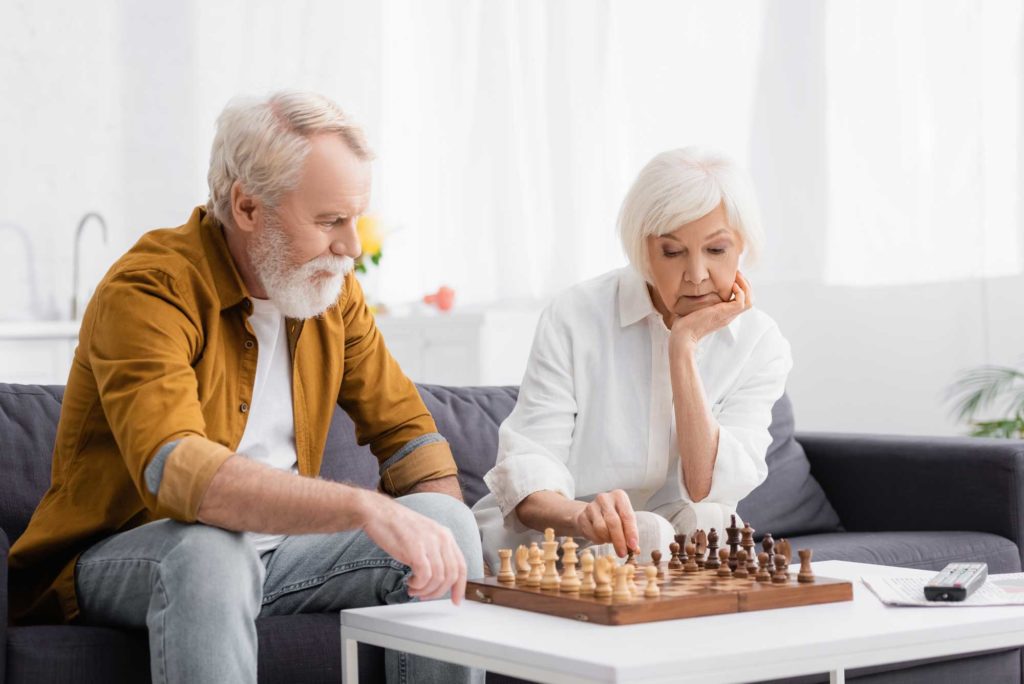 picture of elderly couple playing chess at Waterside Landing